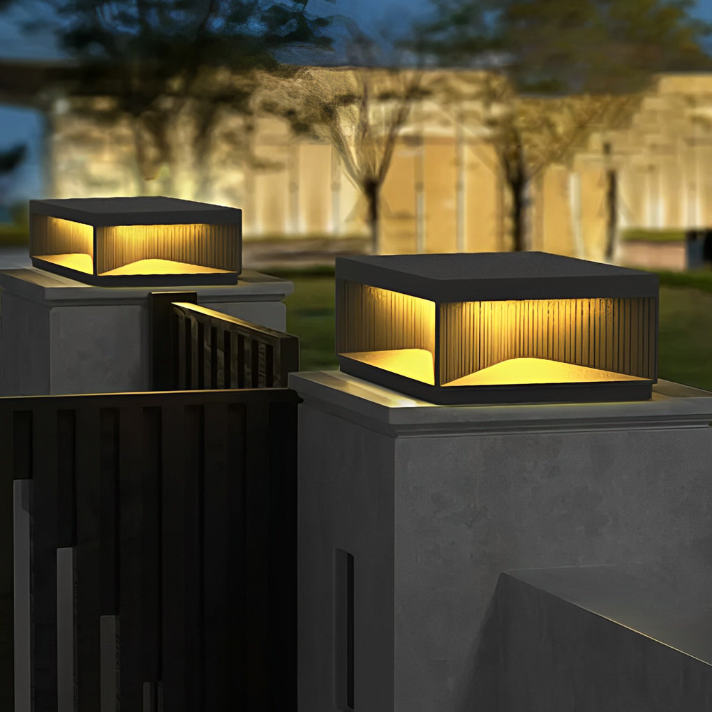 Square outdoor pillar lights grouped on outdoor columns providing decorative architectural lighting.
