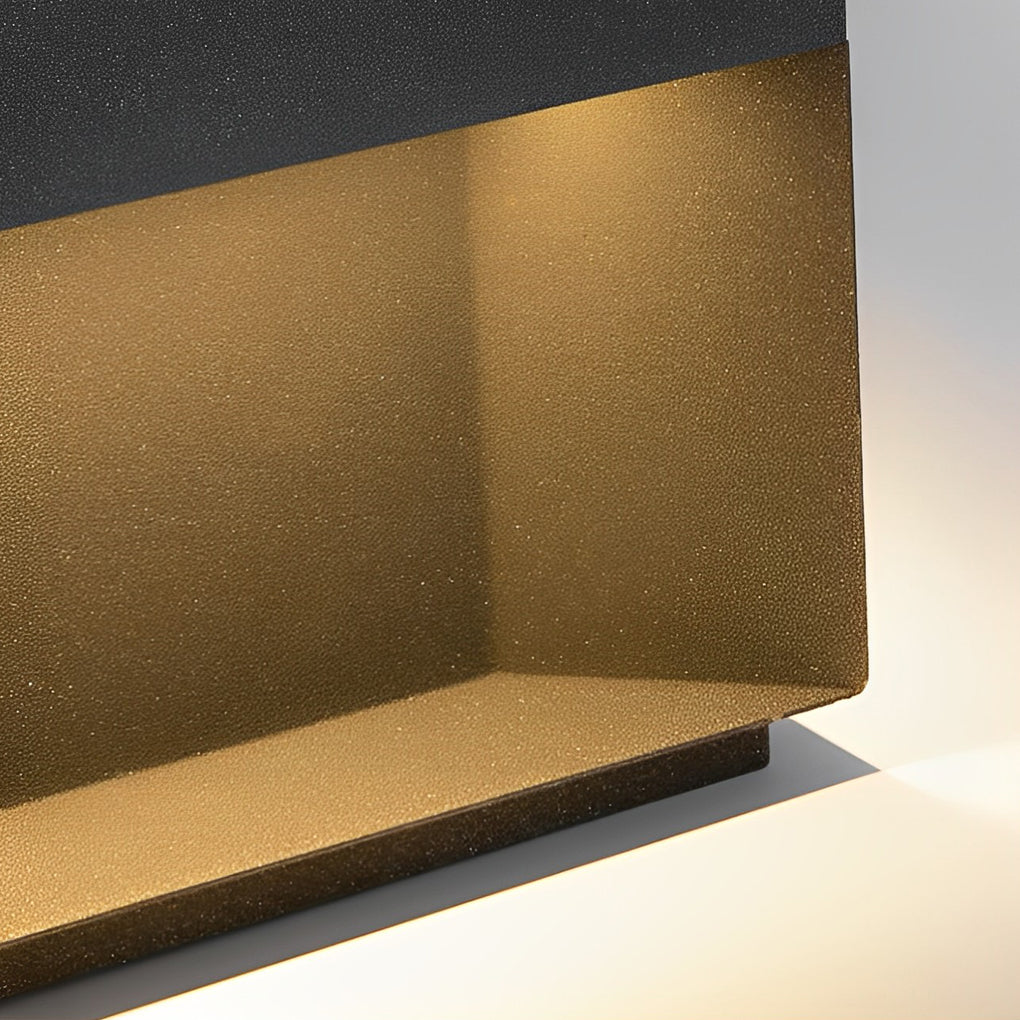 Close-up detail of square solar deck lights showing textured inner reflector and metal housing.