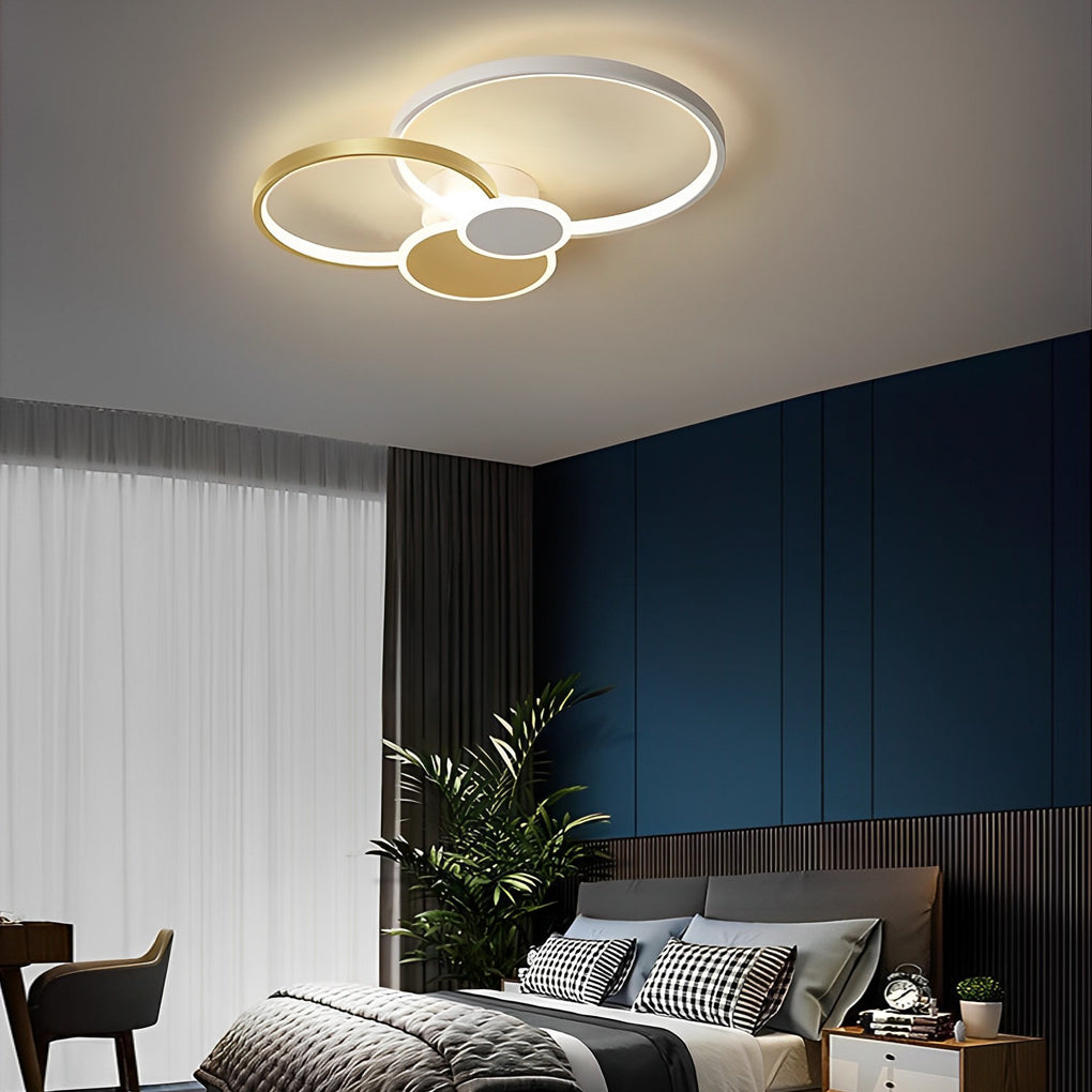 Stacked ring ceiling light installed in a modern bedroom with dark accent walls.