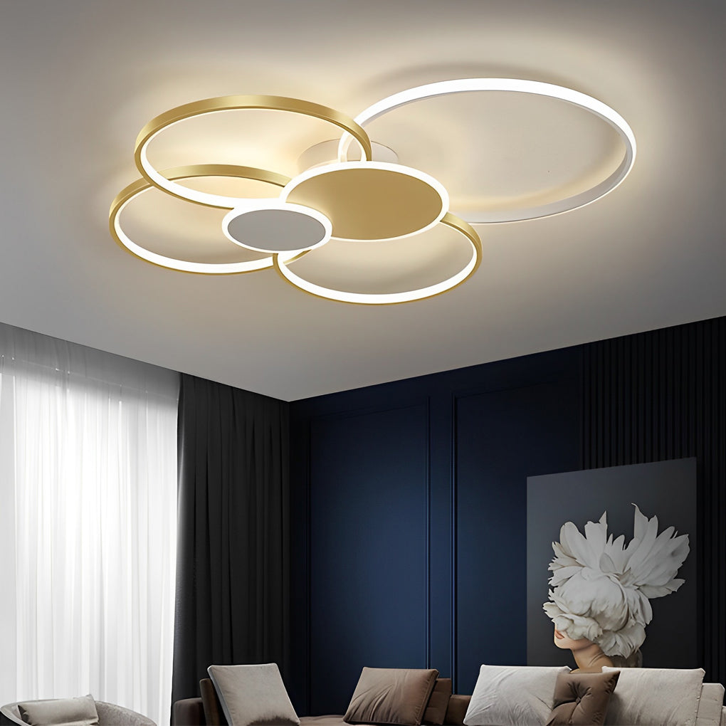 Gold stacked ring ceiling light illuminating a stylish modern living space.