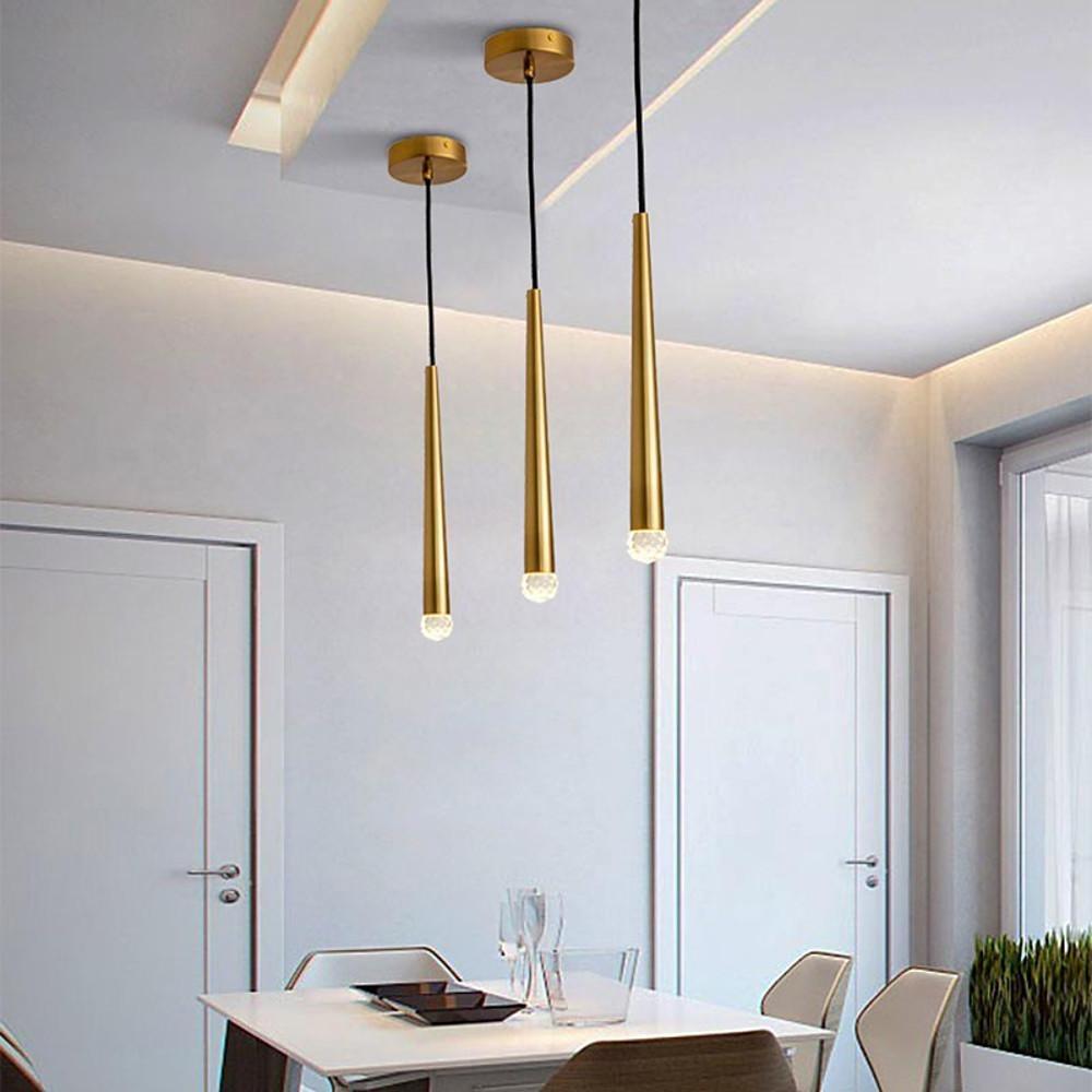 Cluster of gold cone pendant lights at staggered heights in a modern apartment dining area.
