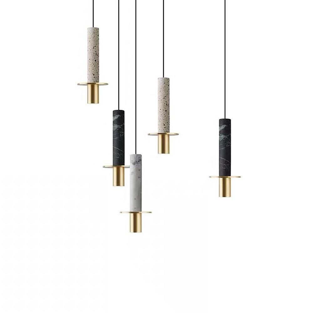A staggered cluster of mixed marble alabaster mini pendant lights with gold hardware details.