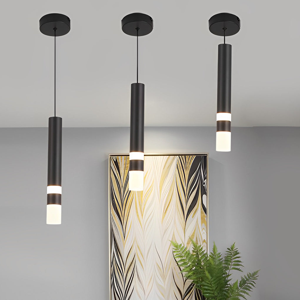 Trio of staggered black and gold LED cylinder pendant lights next to a modern gold painting.
