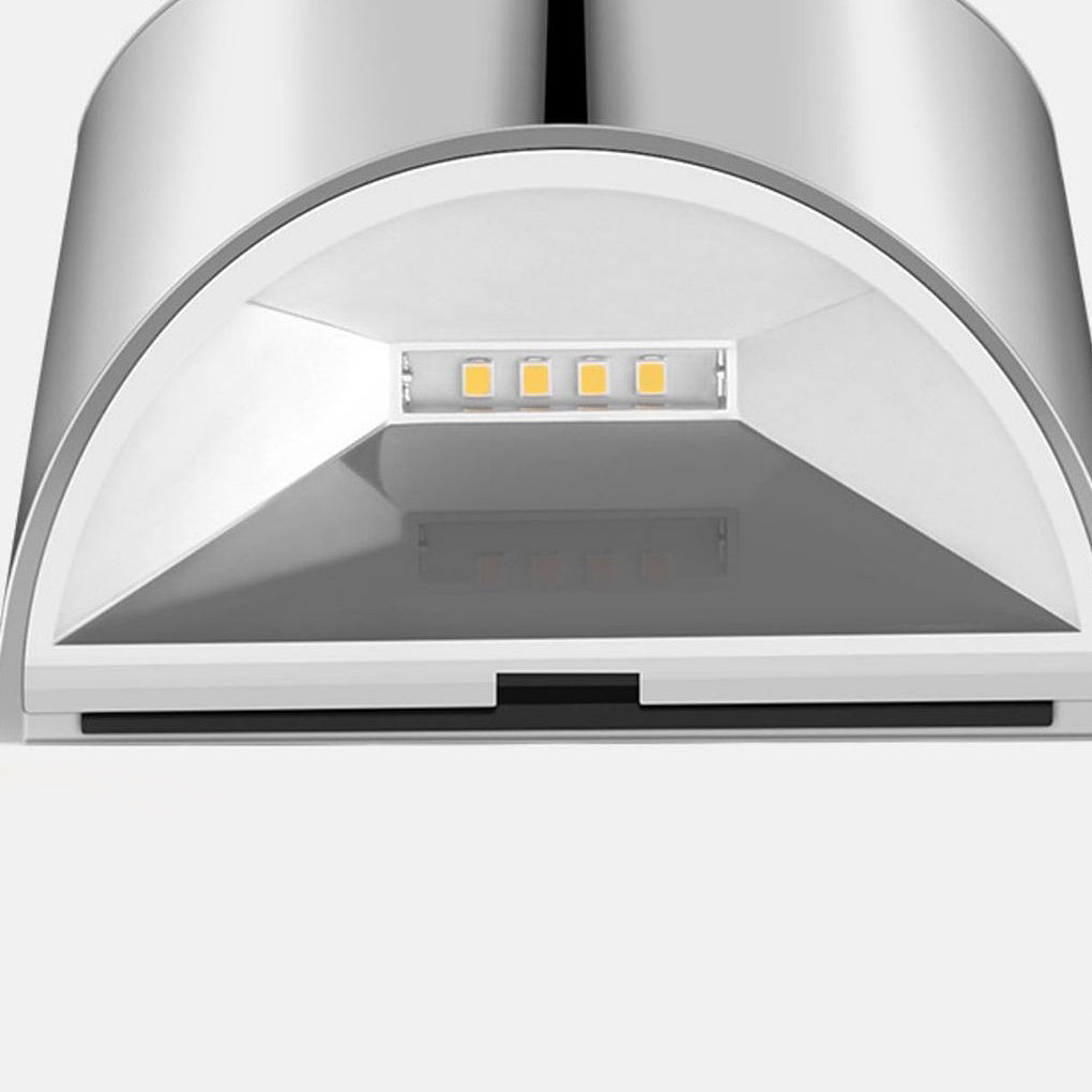 Close-up of a stainless steel wall lamp showcasing its solar panel and modern design.