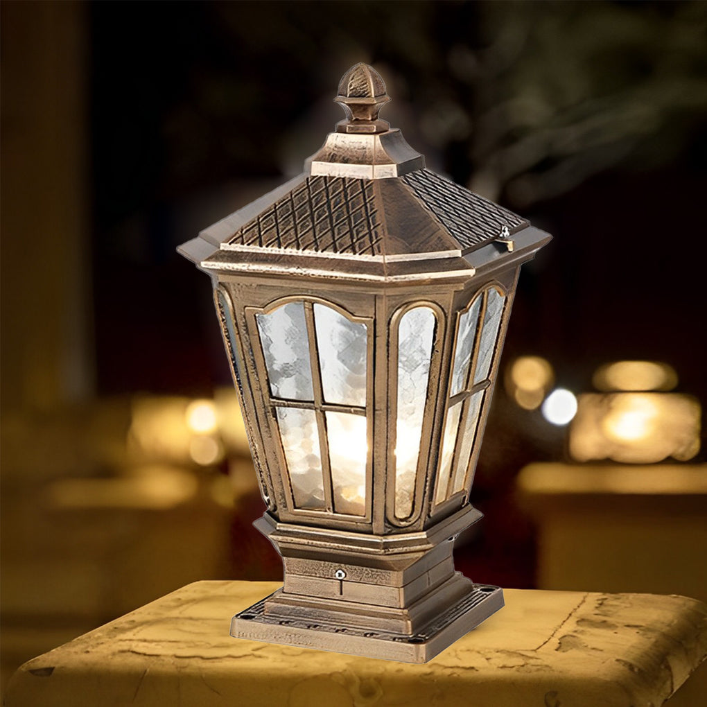 Vintage bronze stone pillar light fixture with textured glass panels displayed in warm evening lighting.