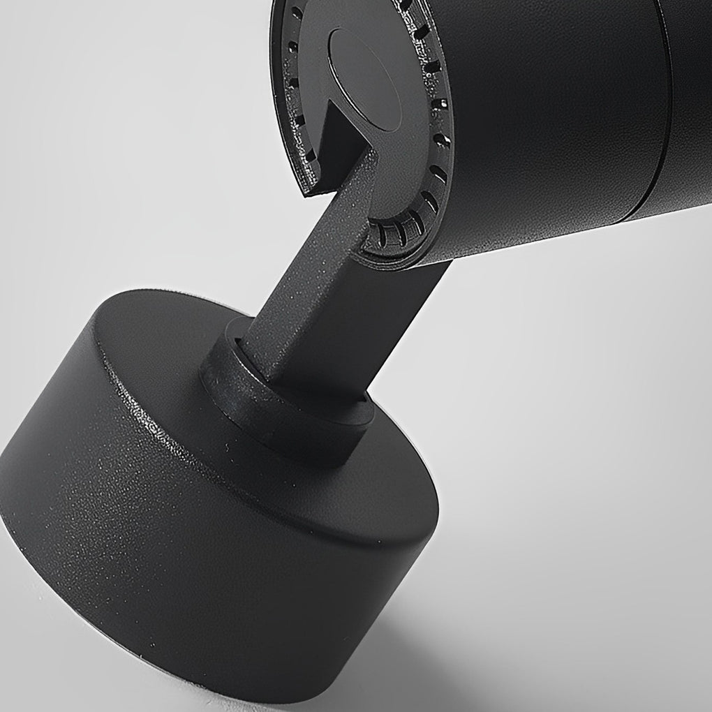 Close-up detail of black surface mounted spot light showing adjustable joint and metal texture.