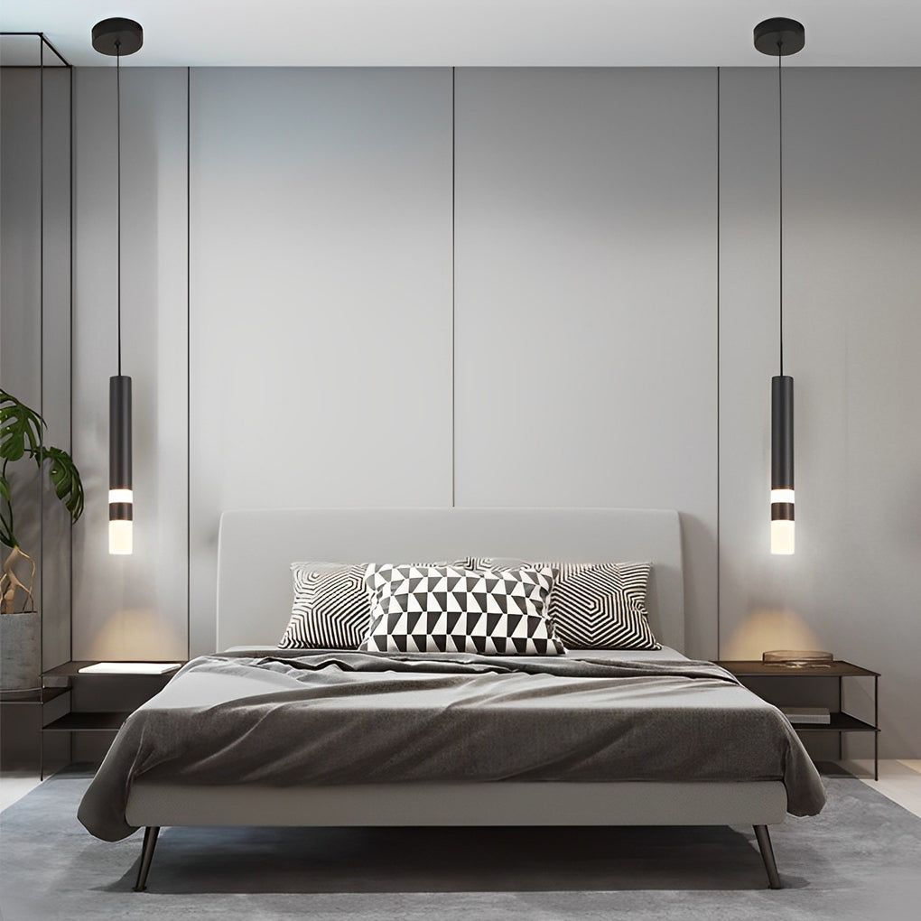 Symmetrical black LED cylinder pendant lights with ring detail in a modern grey bedroom decor.