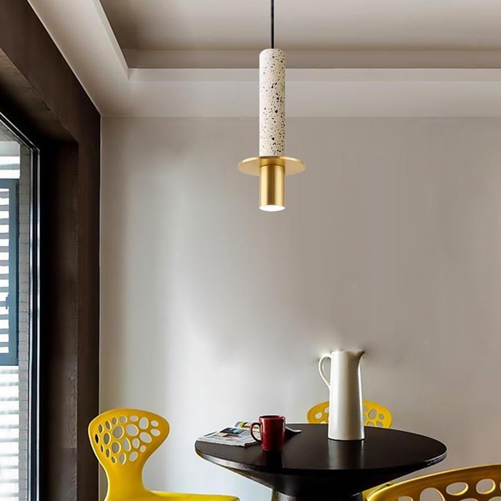 Terrazzo style alabaster mini pendant lights with gold hardware above a modern cafe dining table.