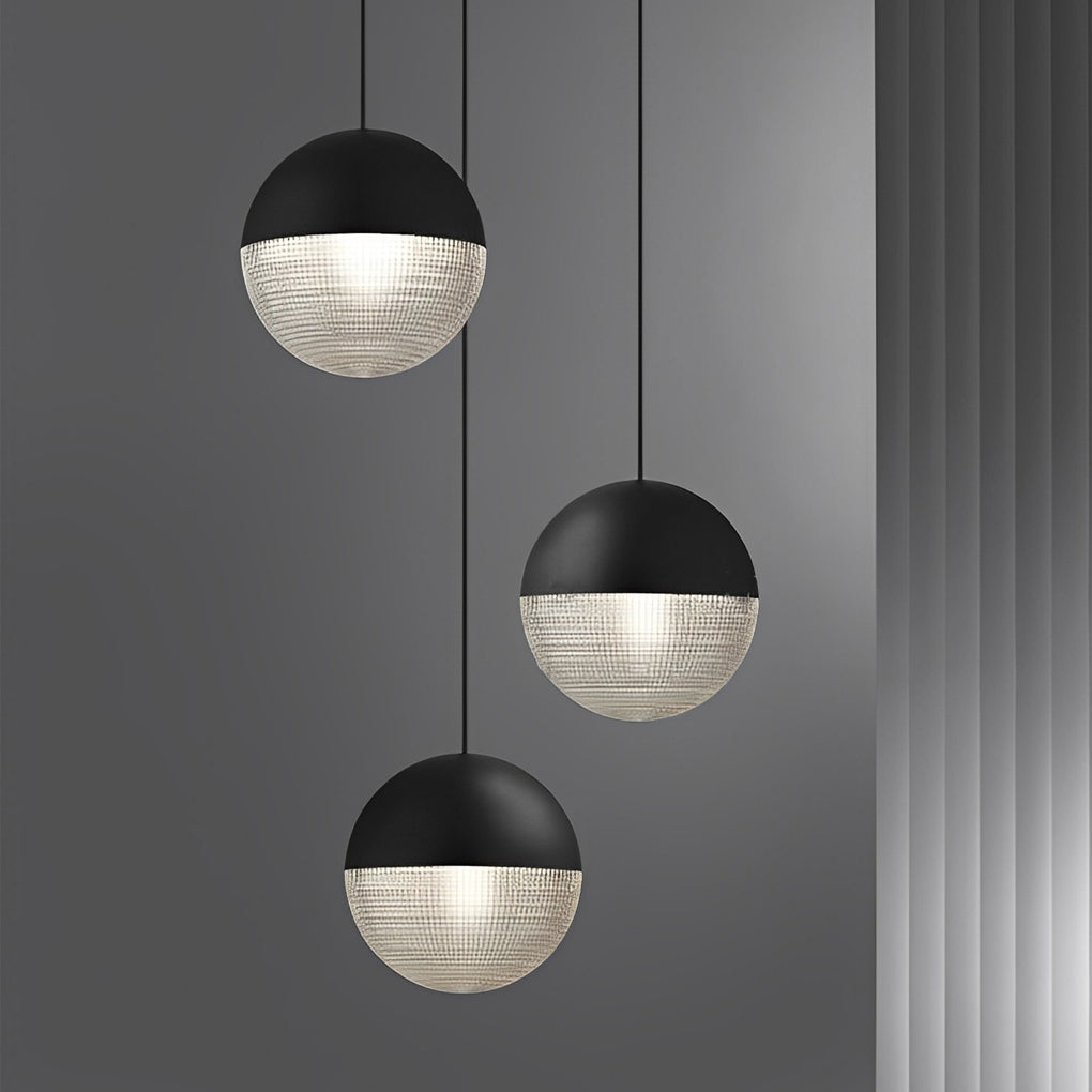 Staggered black globe pendant lights set featuring textured glass for a modern home office.