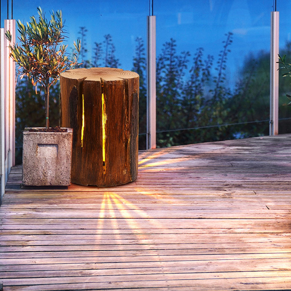 Tree stump lamp with close-up of its natural wood texture and warm light.