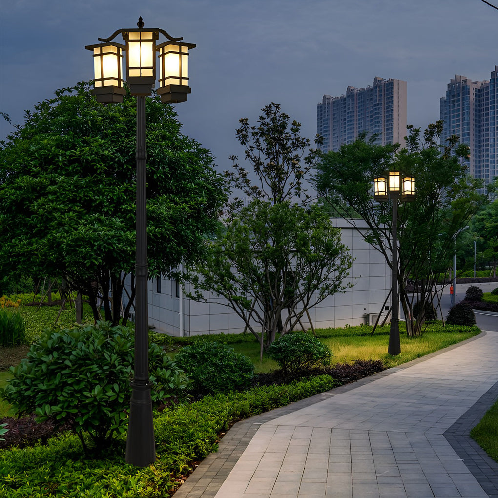 2 head outdoor post light illuminating wide pathway in urban park.