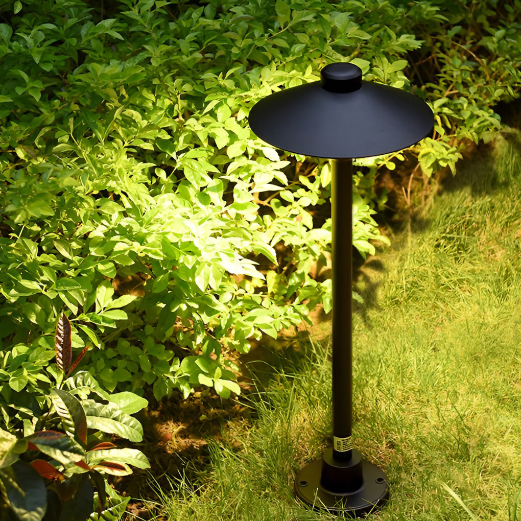Umbrella path lamp illuminating a minimalist outdoor corridor with focused glow.