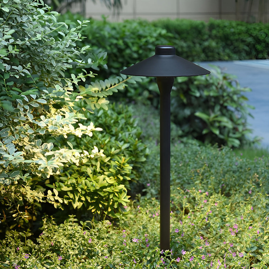 Umbrella path lamp enhancing a modern outdoor seating area with warm light.