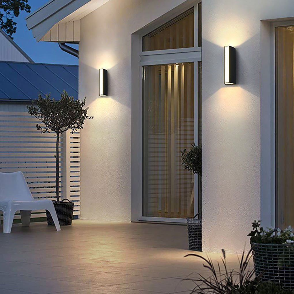 Up down cylinder sconce used along a covered outdoor walkway, creating uniform and elegant architectural lighting.