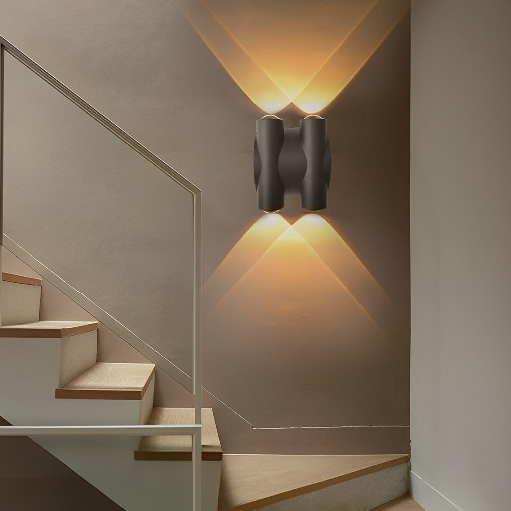 Up and down light wall sconce enhancing a modern outdoor seating area with warm light.