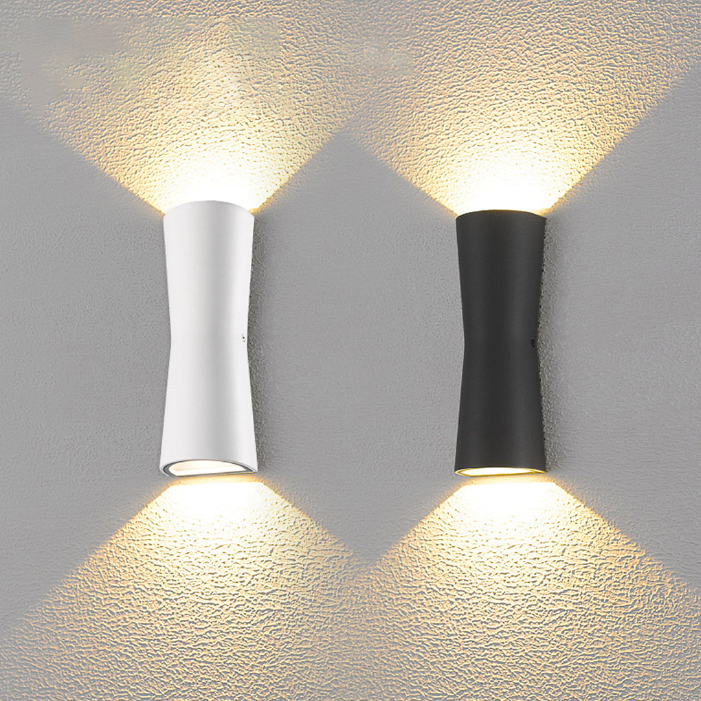 Warm up and down wall light accenting a vertical wood panel interior wall.