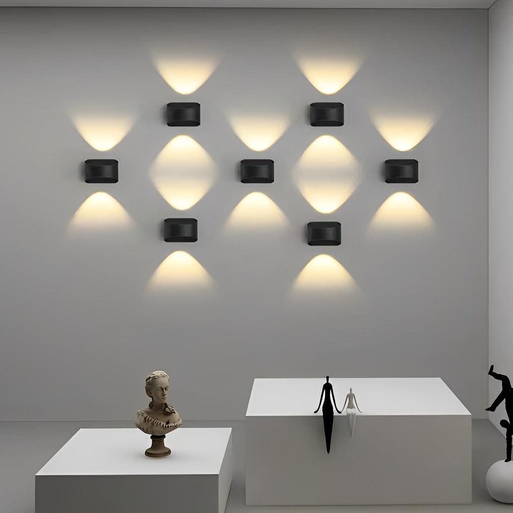 Multiple up and down wall sconce lighting fixtures providing ambient light in a living room.