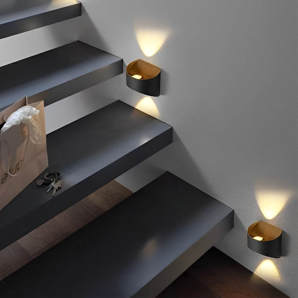 Up and down wall sconce lighting mounted above a staircase, enhancing modern interior design.