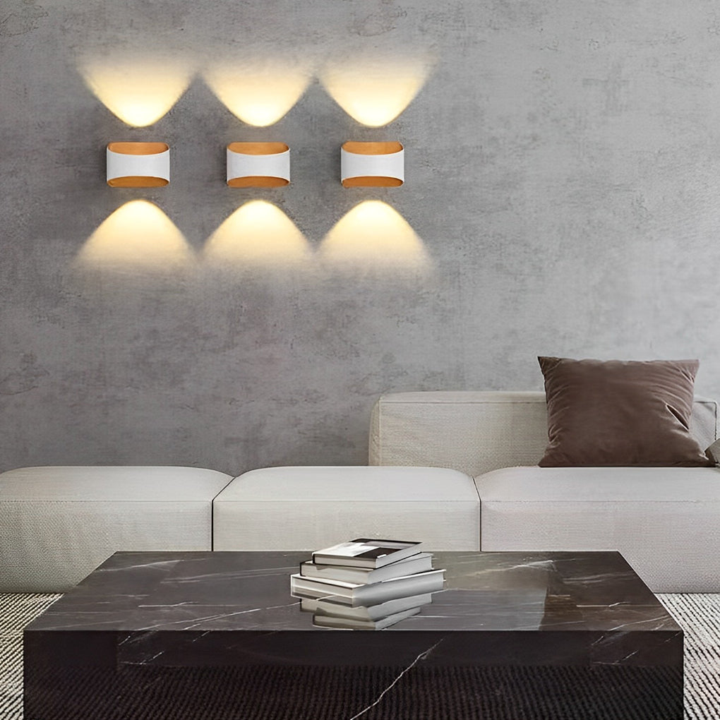 Set of up and down wall sconce lighting fixtures creating a symmetrical light effect indoors.
