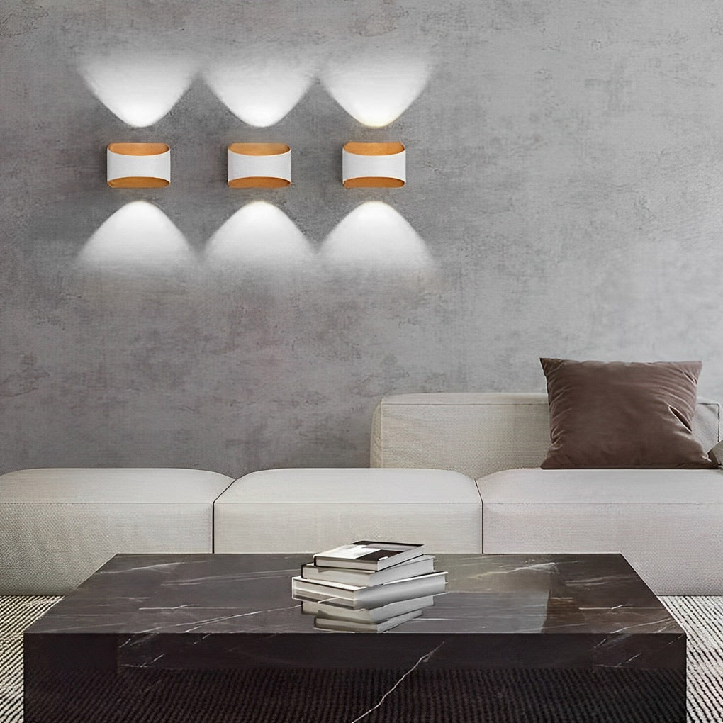 Up and down wall sconce lighting with a white finish, installed in a minimalist living room.