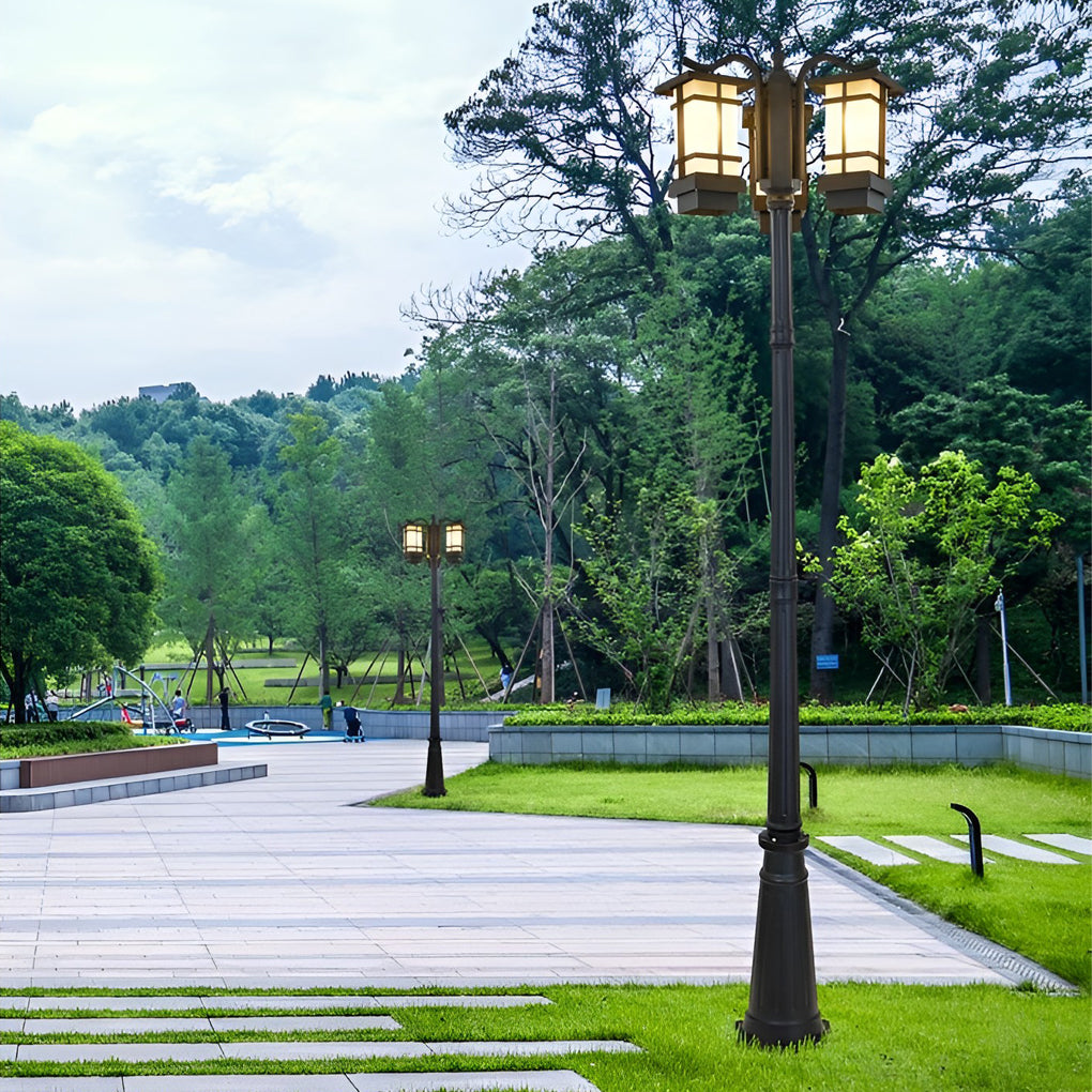 2 head outdoor post light with vintage design beside modern building.