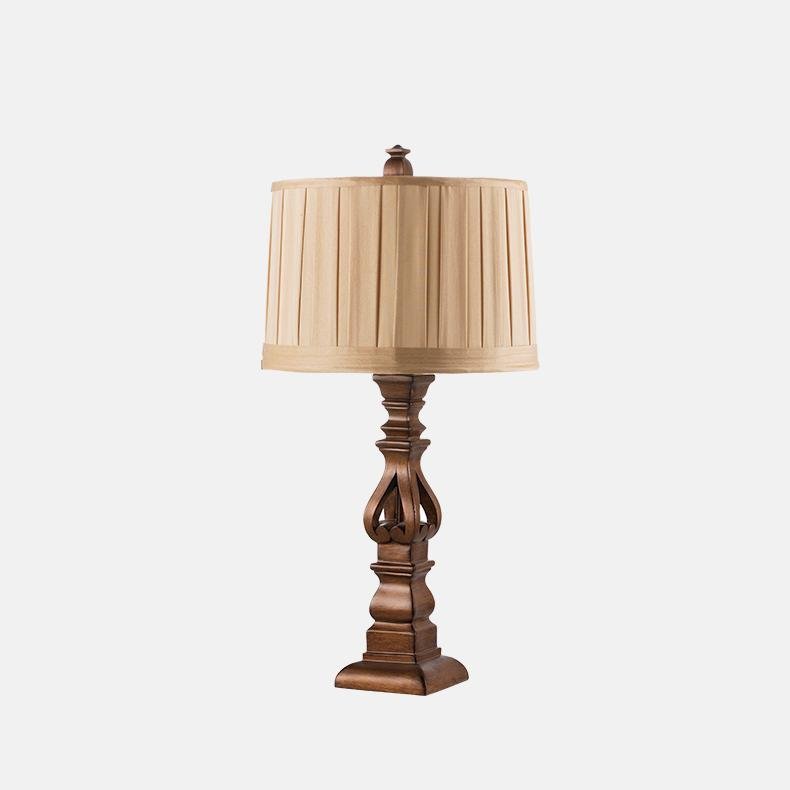 Vintage wood table lamp with a striped shade, enhancing a vintage-style interior.