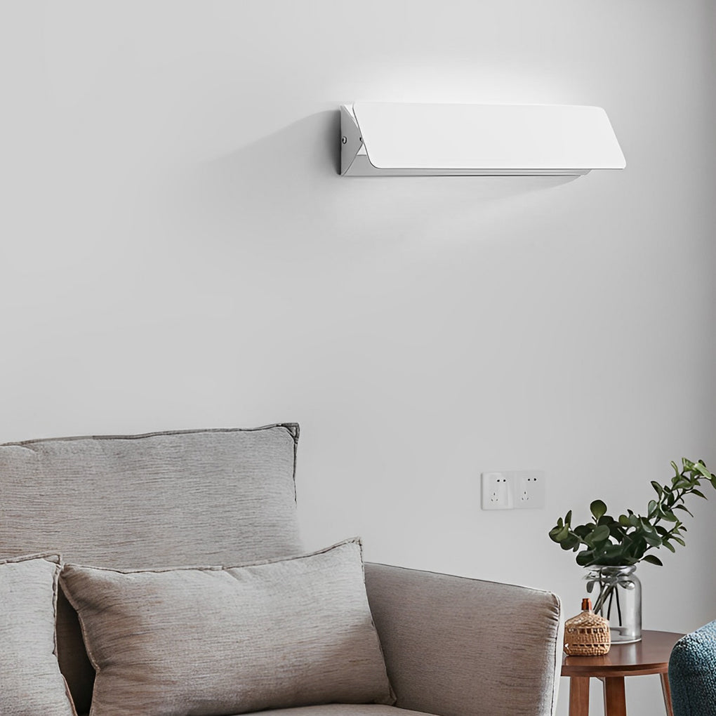 Modern wall adjustable light used in cozy living room setting.