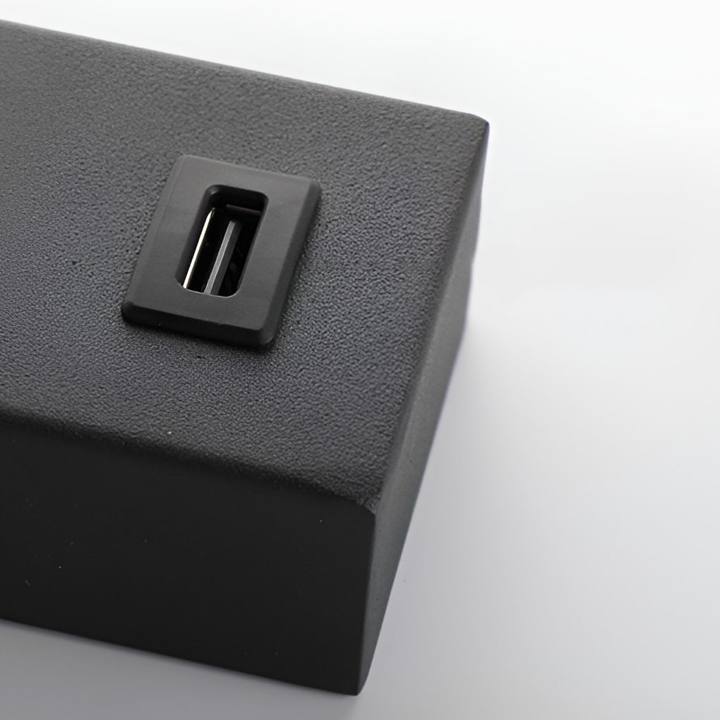 Wall lamp with USB charger with close-up of its sleek design and light output.