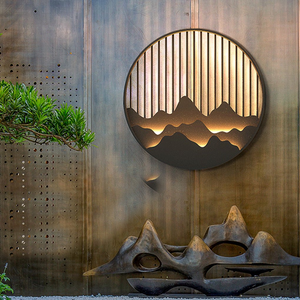 Wall mountain light displayed beside a sculpture in a modern garden.