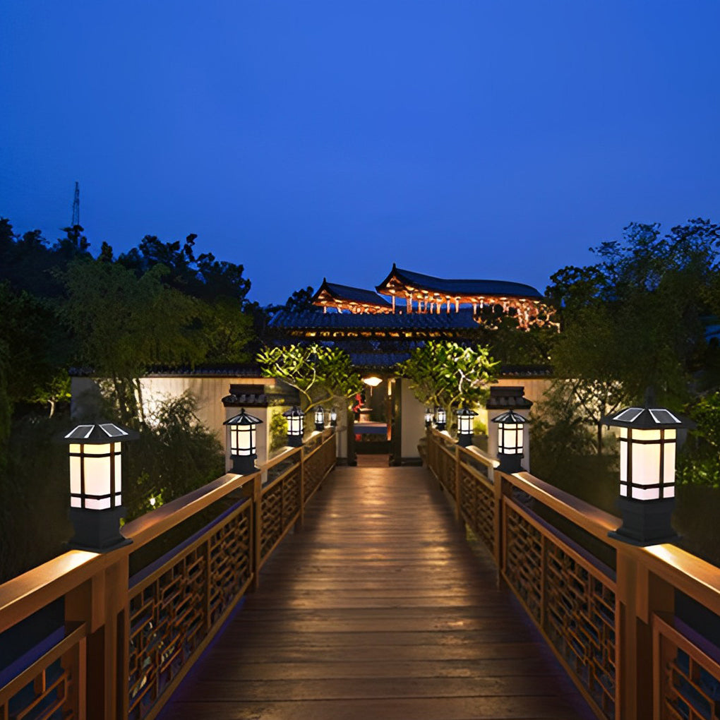 Wall pillar lights outdoor enhancing a waterside pathway with warm illumination.