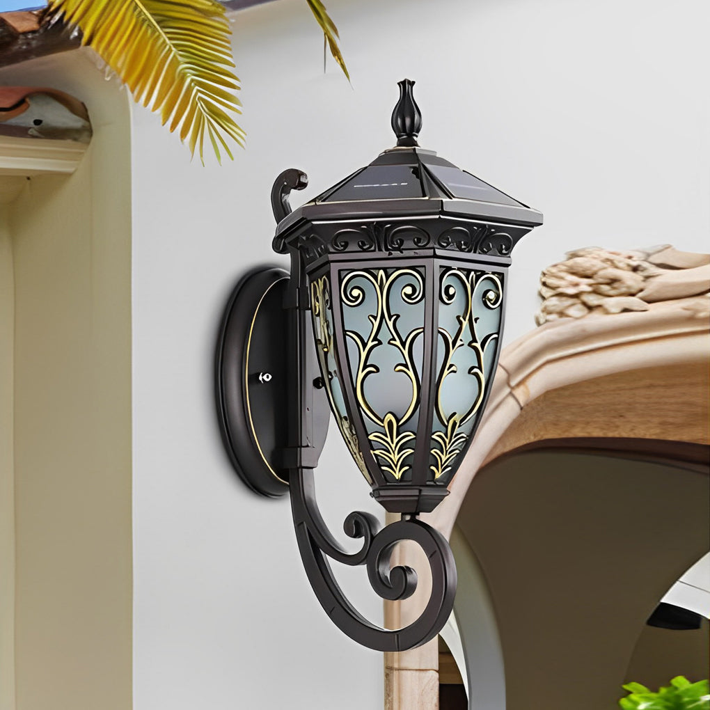 Wall sconce lantern with a classic design, installed on a stone wall near a garden.
