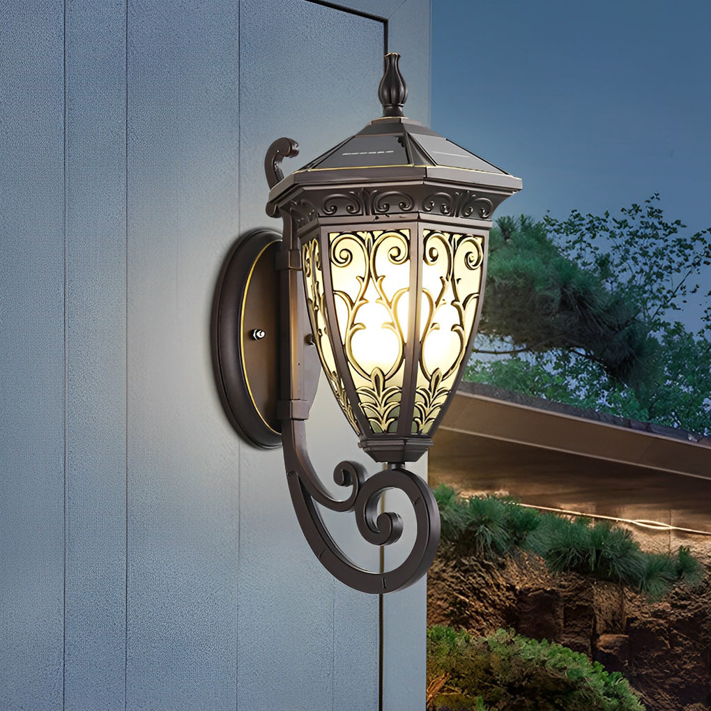 Wall sconce lantern with a decorative design, providing ambient light on a brick wall.