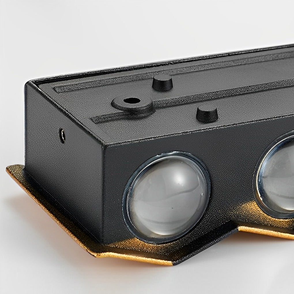 Wall sconce up-down light with a close-up of the black and gold fixture.