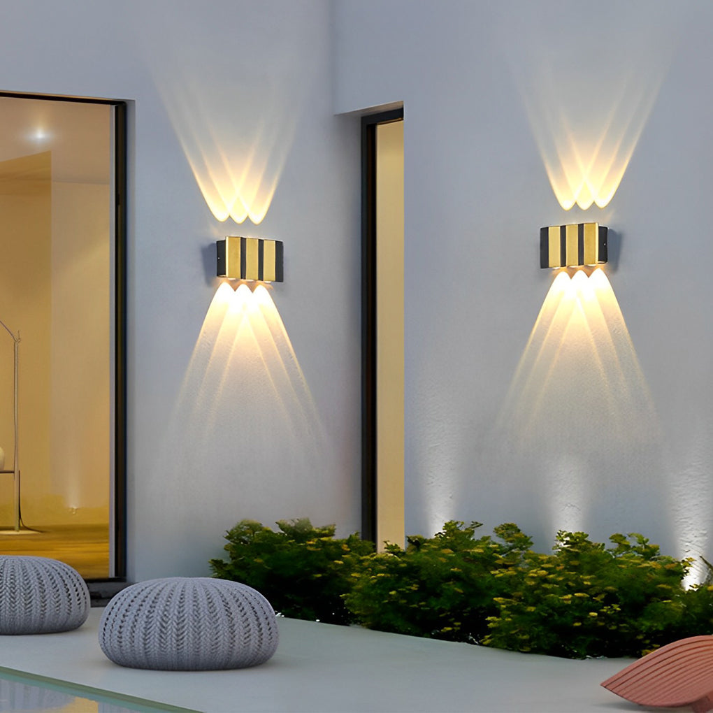 Wall sconce up-down light enhancing a contemporary patio with warm, inviting glow.