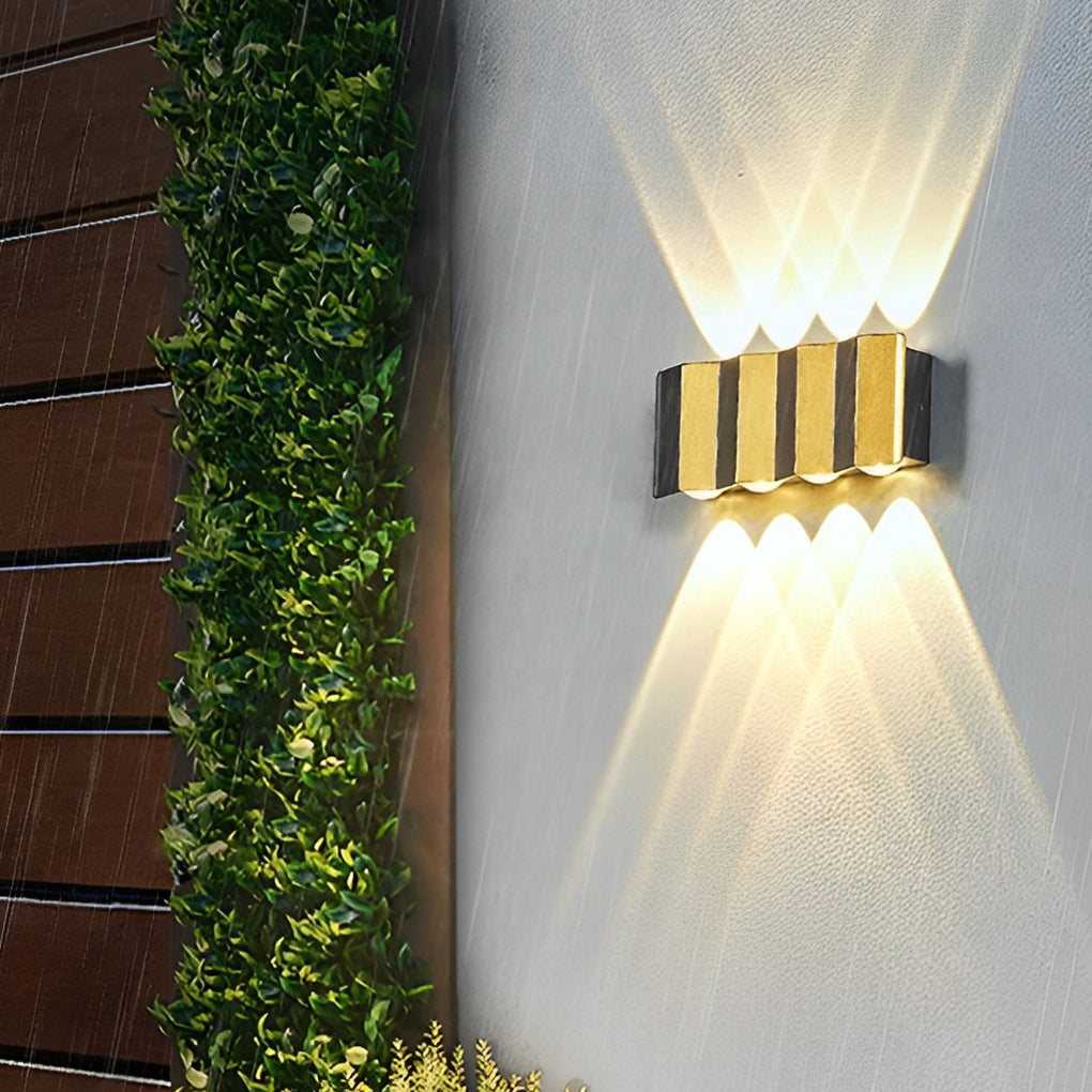 Wall sconce up-down light illuminating a modern outdoor entrance with elegant design.