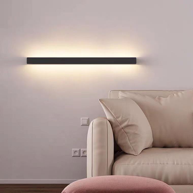 Long outdoor wall lights providing warm glow, installed on dark wall for modern and stylish outdoor lighting.