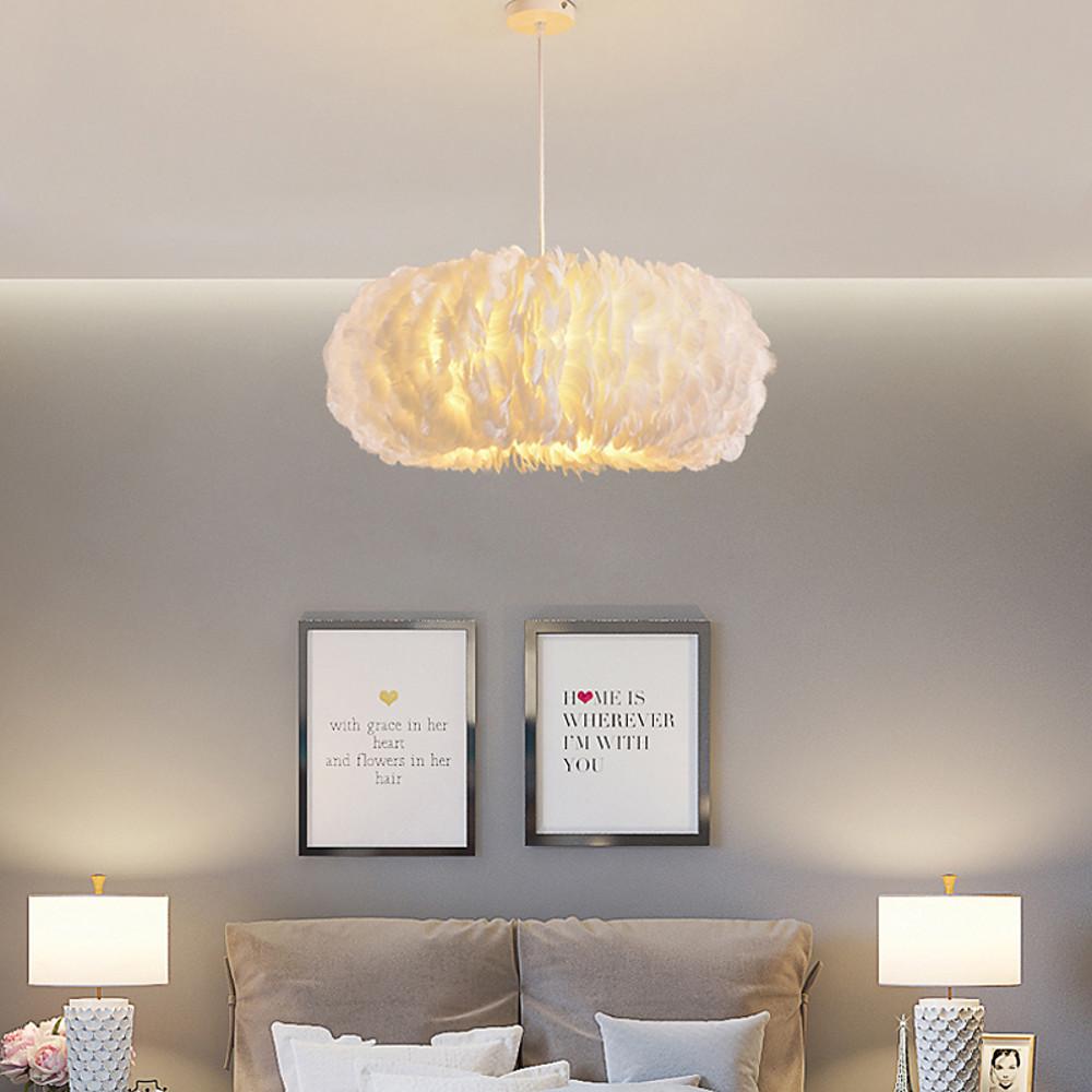 Cozy bedroom atmosphere created by a warm white fluffy hanging light with feathered texture.