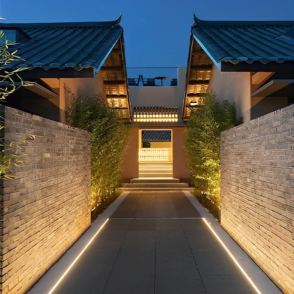 Waterproof LED light strips lining a narrow courtyard passage, guiding the walkway with warm and uniform lighting.