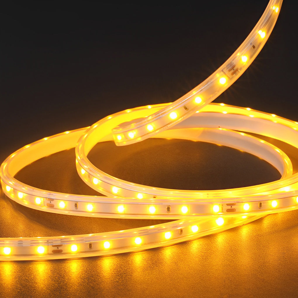 Close-up of waterproof LED light strips coiled on the floor, showing flexible design and bright warm light output.