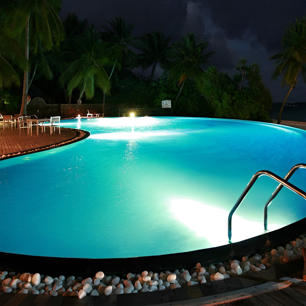 Waterproof outdoor spotlights providing bright illumination for a modern pool with steps and pebble details.