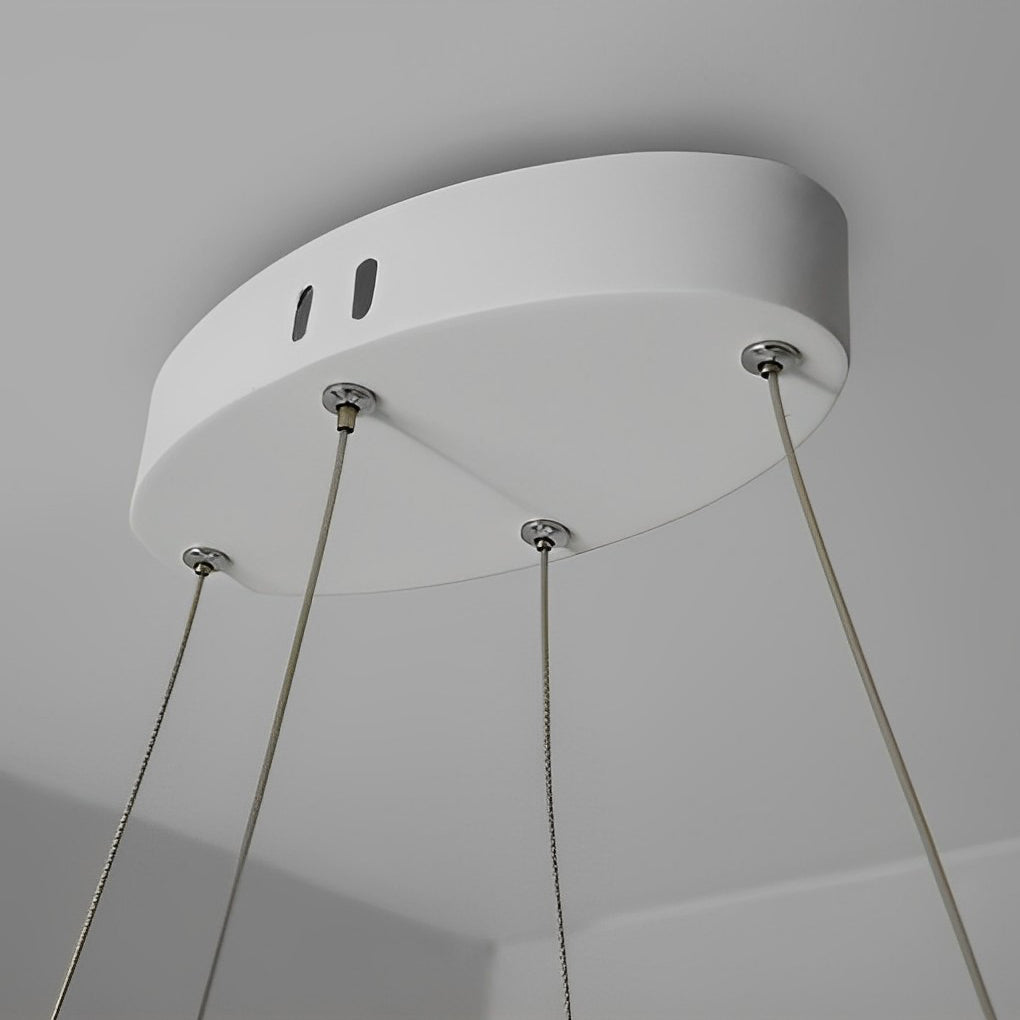 White chandeliers displayed from above, highlighting the clean lines and modern aesthetic.