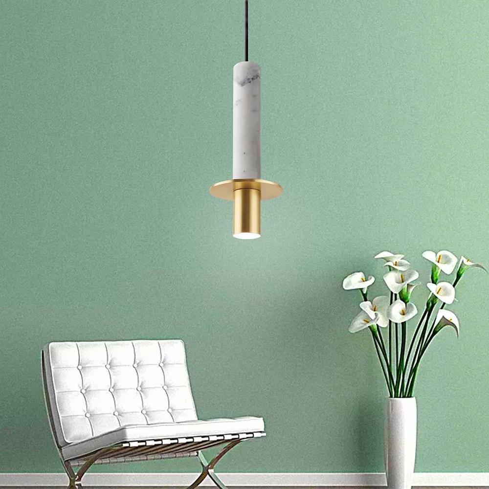 White marble alabaster mini pendant lights with gold hardware against a soft green feature wall.