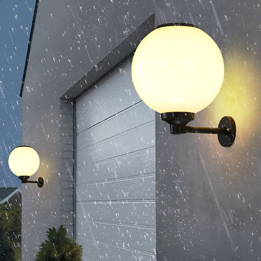 White outdoor globe wall sconce with close-up of its sleek design and light output.