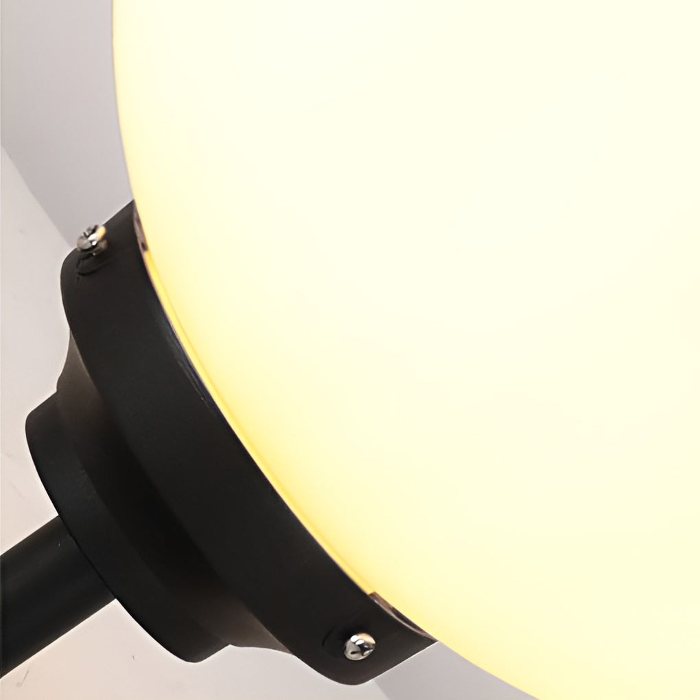 White outdoor globe wall sconce with side view showing depth and installation.