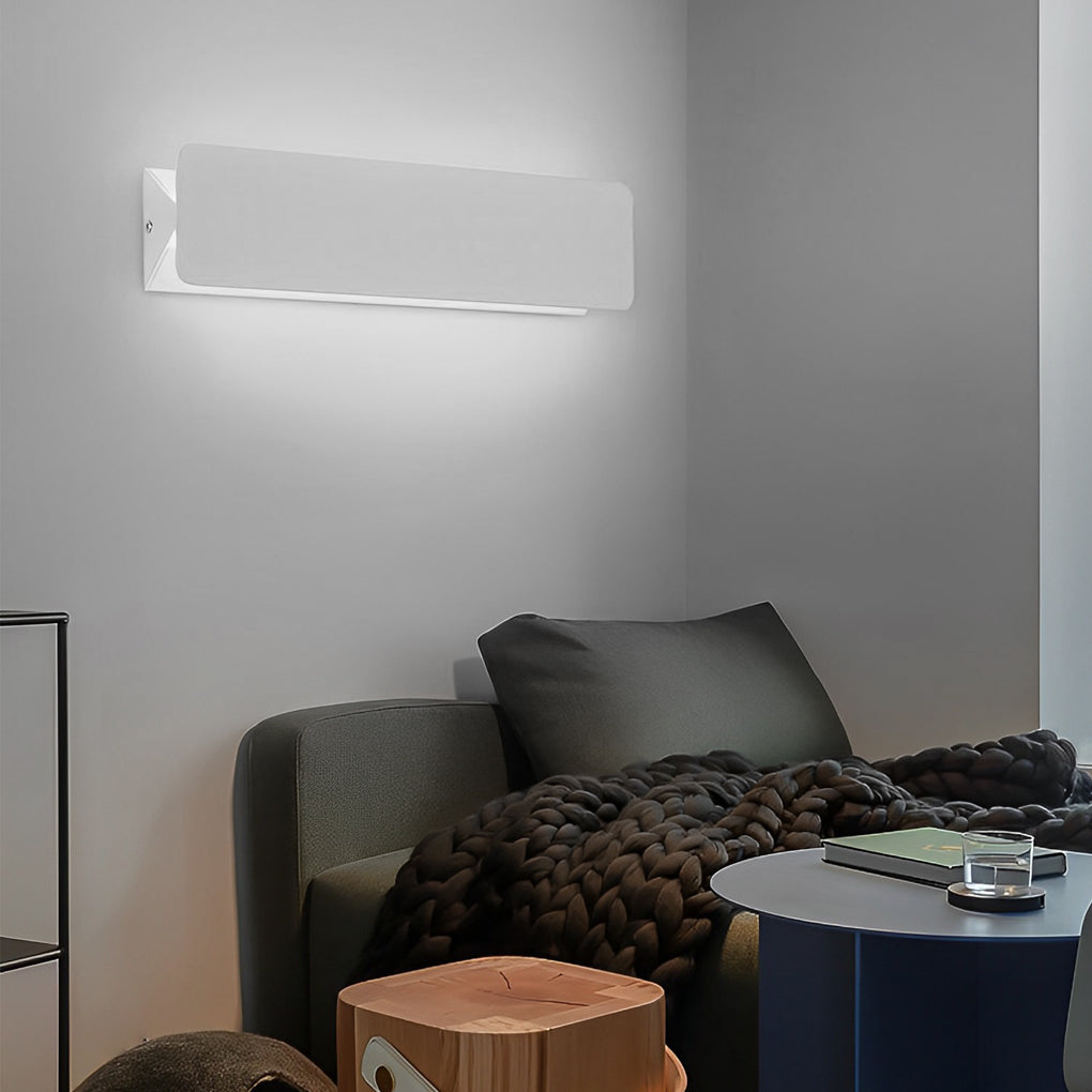 White wall adjustable light used as ambient lighting in living room corner.