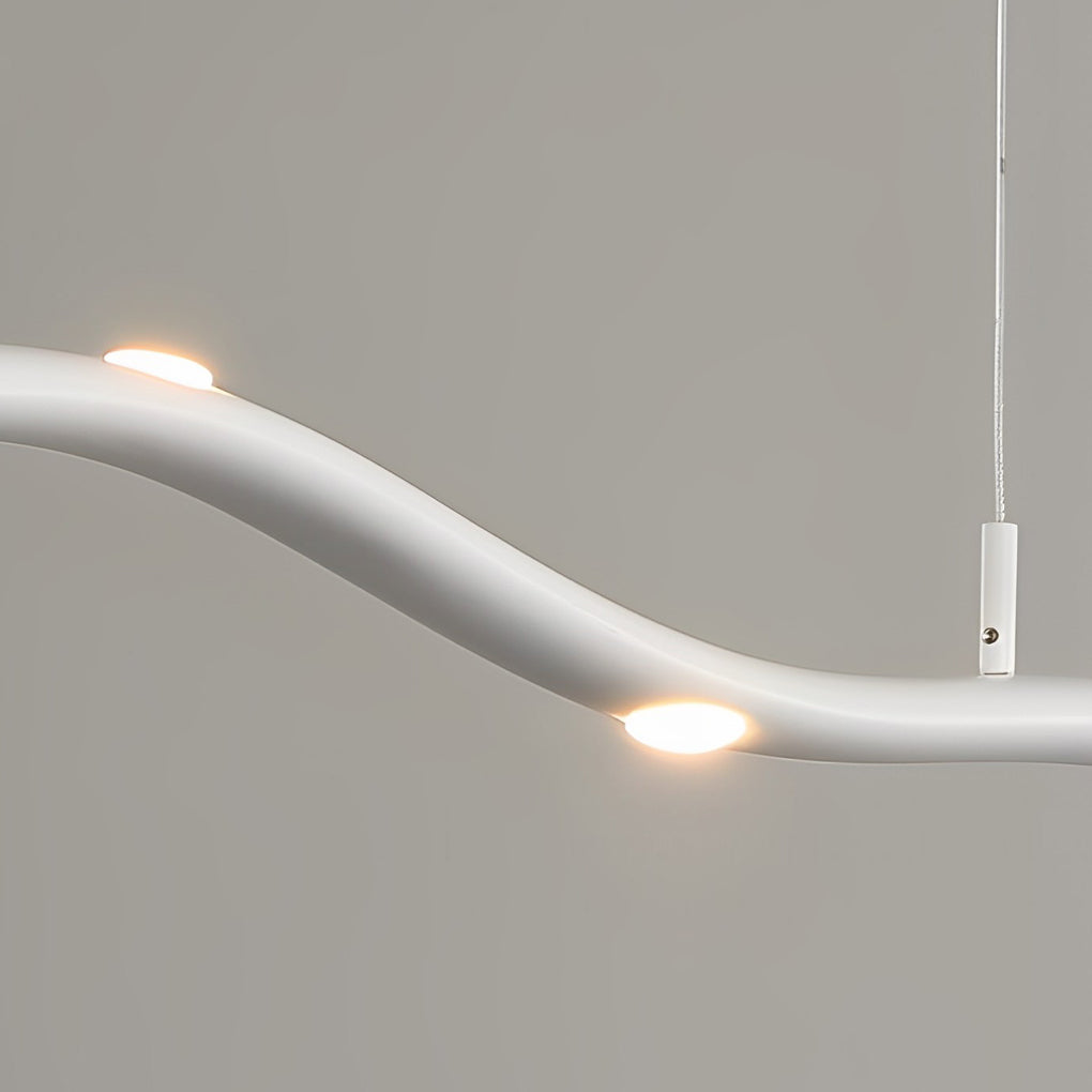 White wave pendant light with a curved structure, enhancing a modern interior.