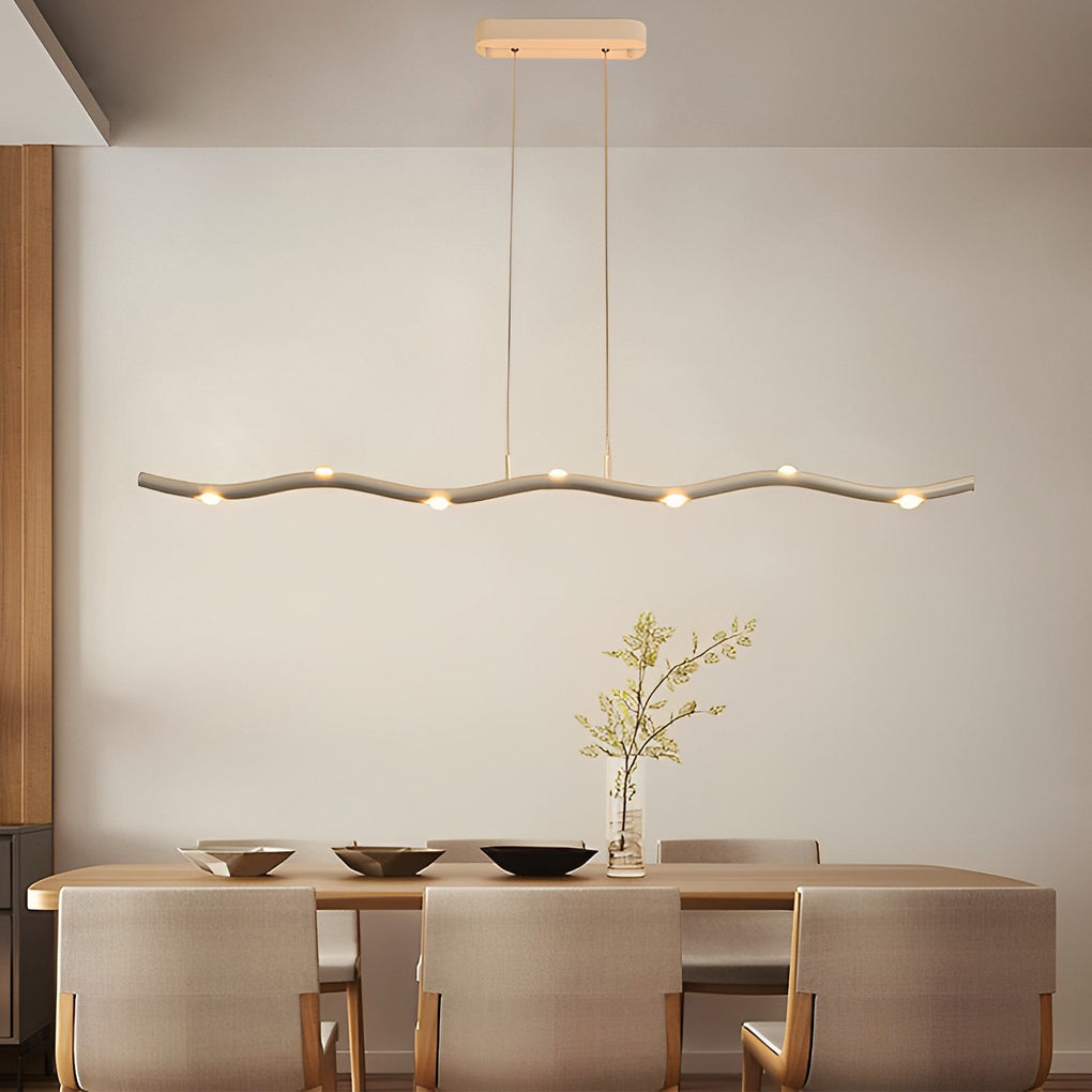 White wave pendant light with a curved design, installed in a stylish kitchen.