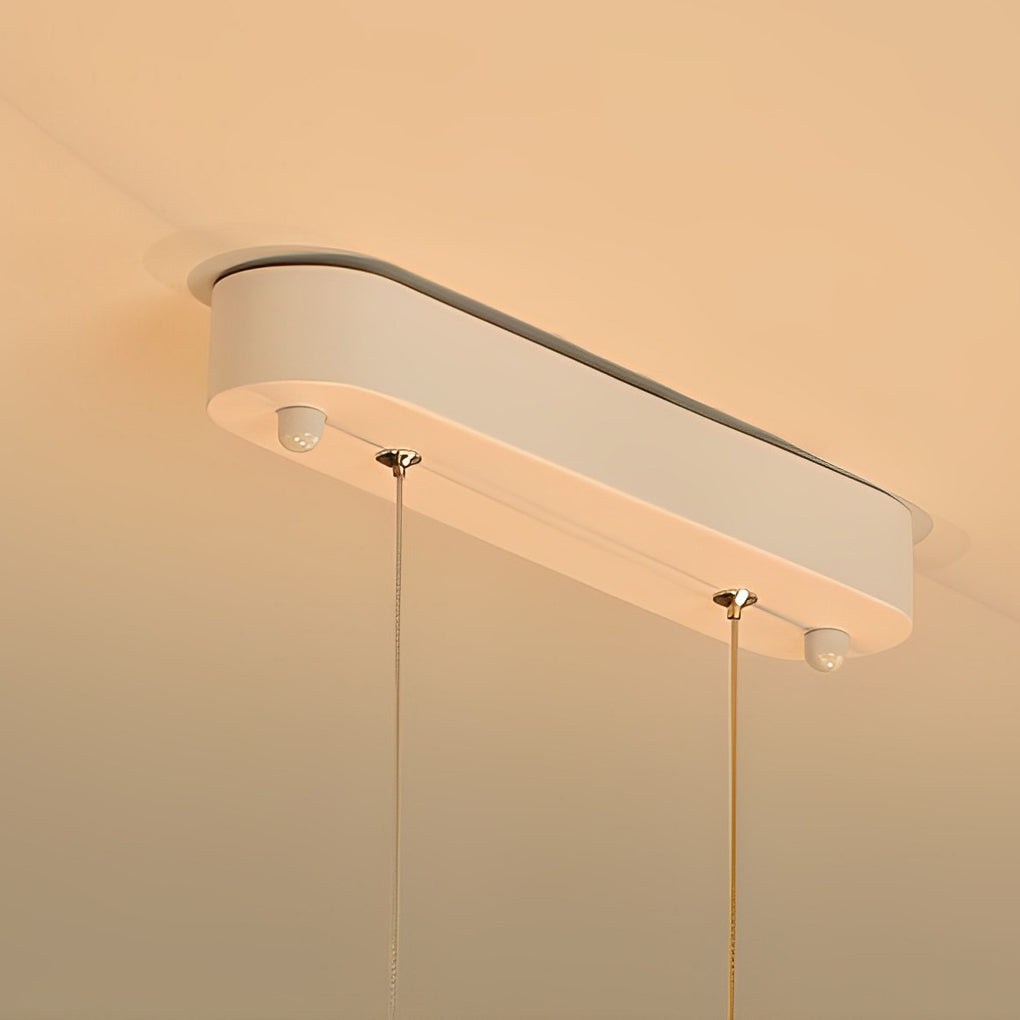 White wave pendant light with a minimalist design, providing focused lighting in a dining area.