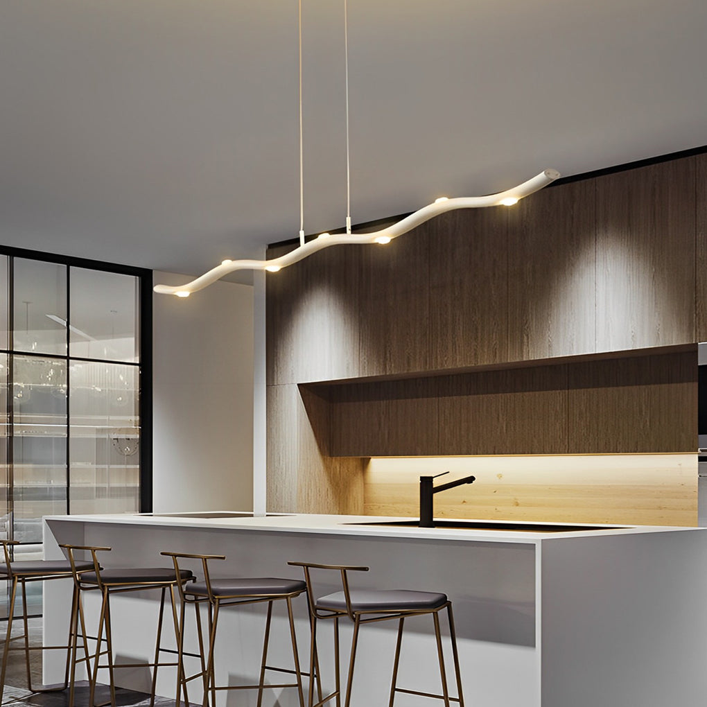 White wave pendant light with a sleek finish, illuminating a contemporary living room.