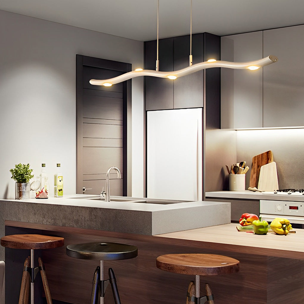 White wave pendant light providing soft lighting above a dining table in a modern home.